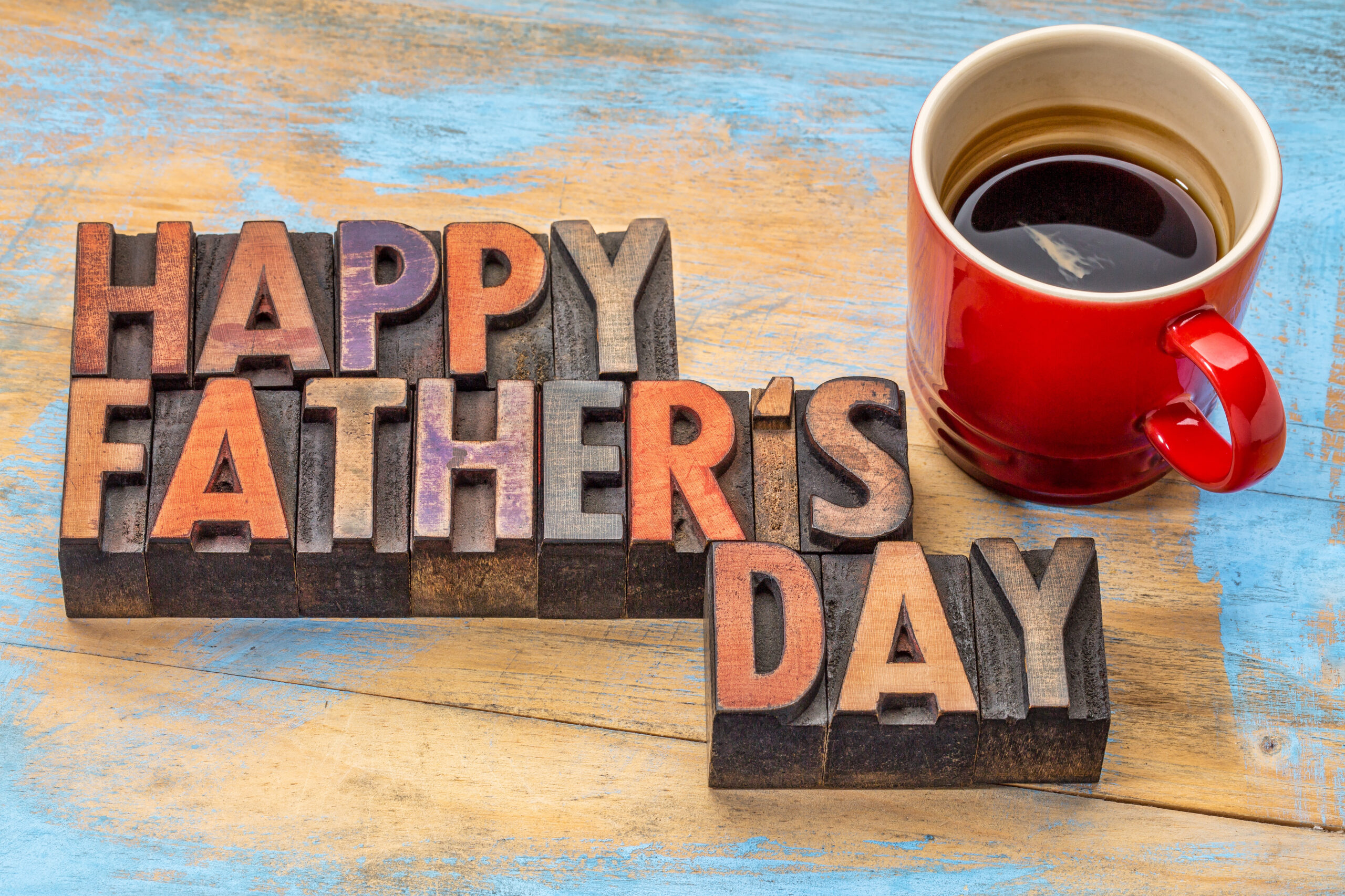 blocks spelling out happy fathers day with coffee mug