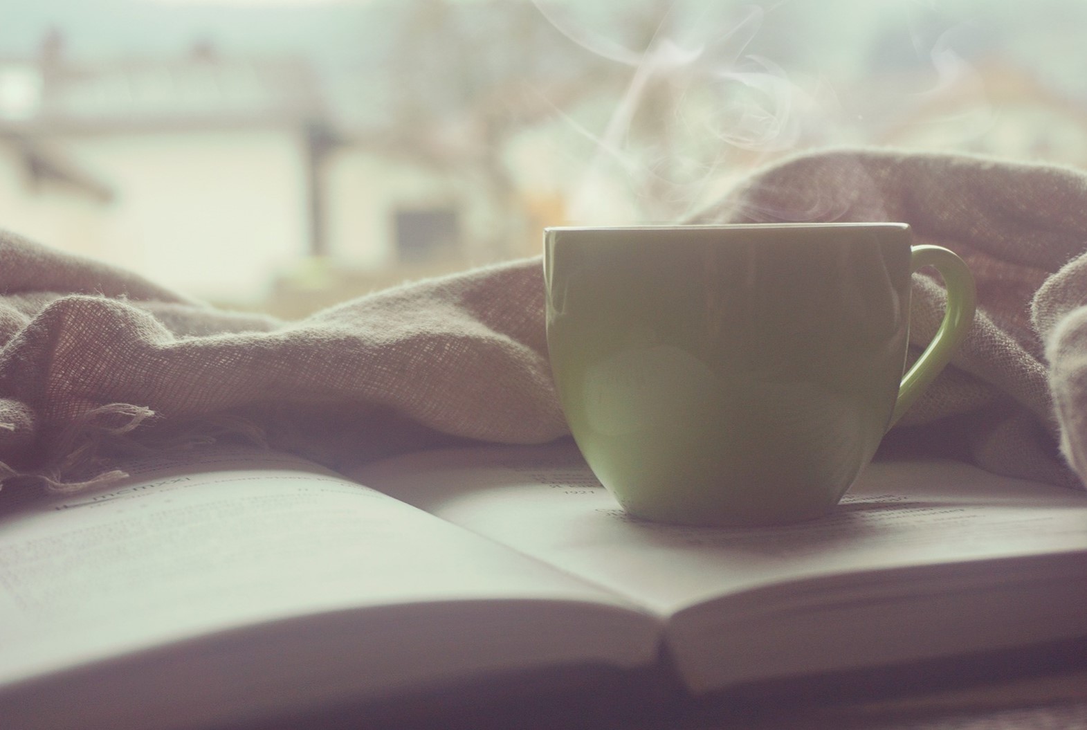 relaxing cup of coffee with book and blanket