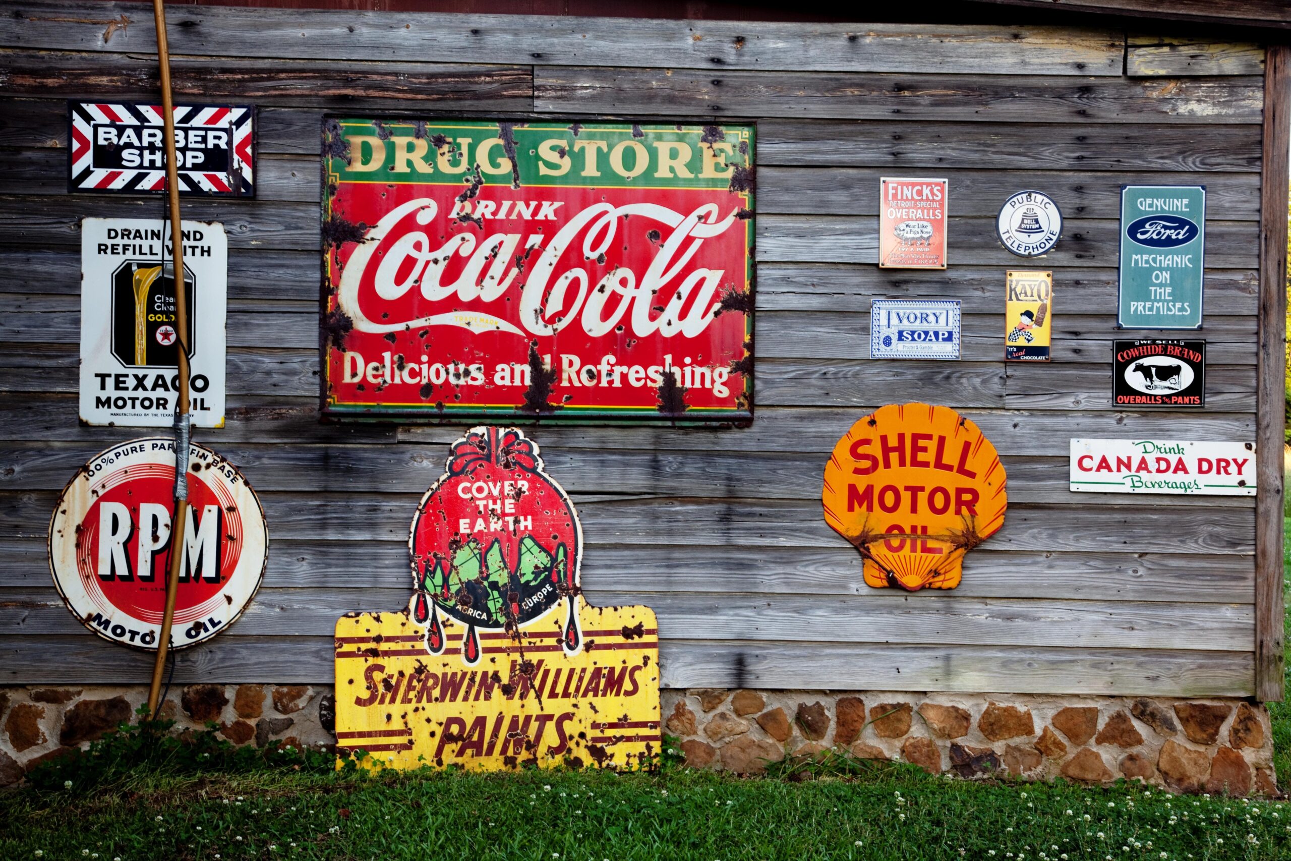 antique style signs against wooden wall