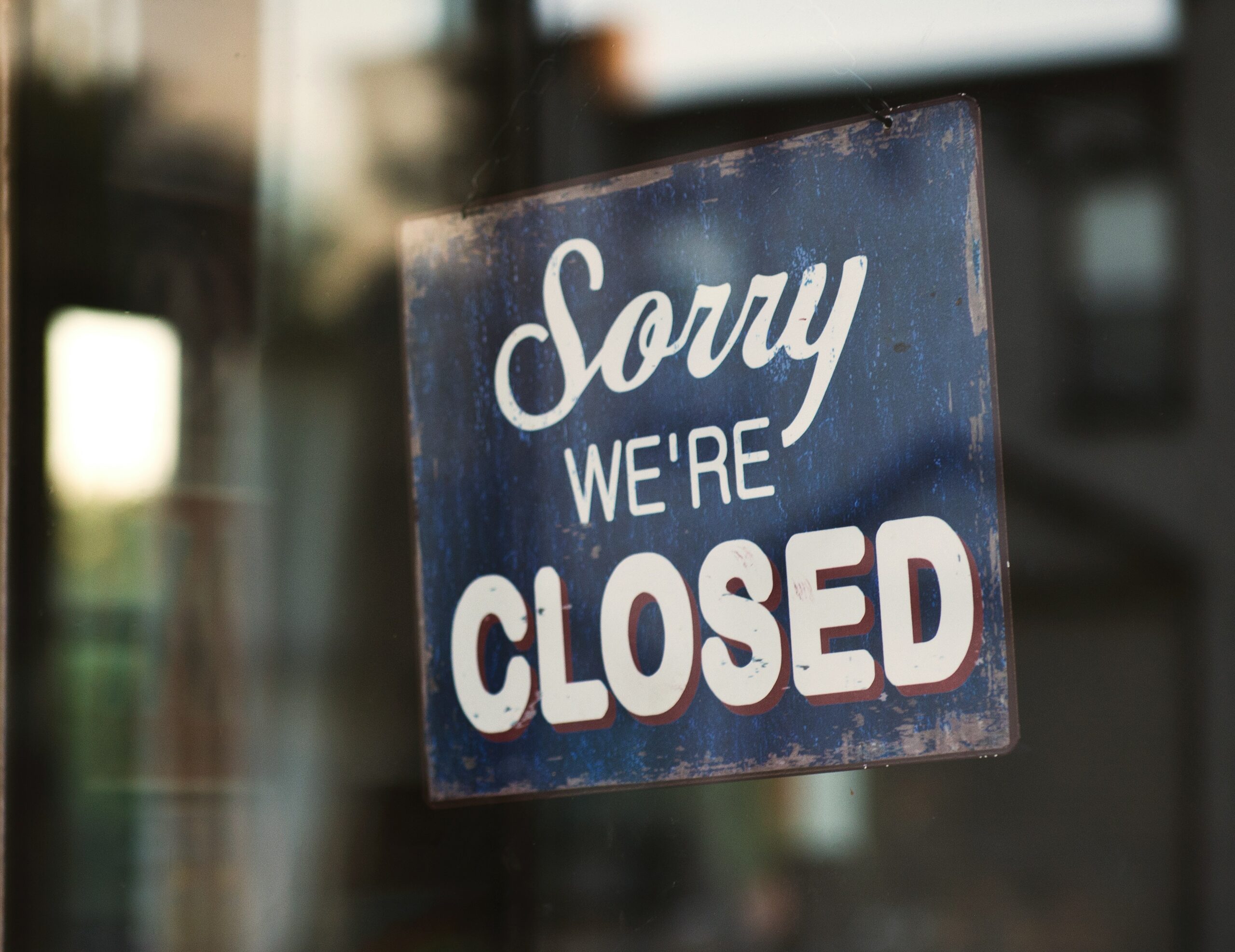 sign in a window saying "Sorry We're Closed"