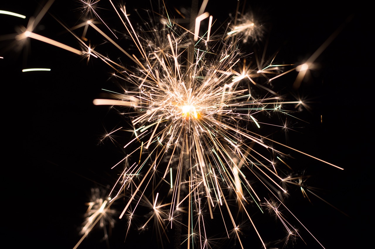 sparkler lit in the dark against black background